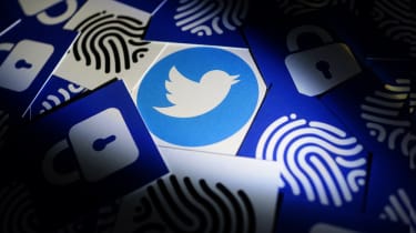 The Twitter logo on a card surrounded by other cards with images such as fingerprints and locks