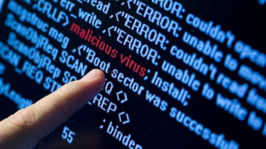 Finger pointing towards malware on a piece of code
