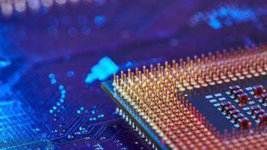 The corner of a CPU chip seen on a circuitboard 