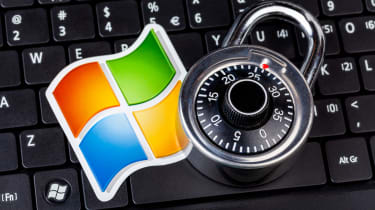 The Microsoft logo and a padlock placed on a black keyboard