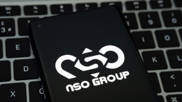 The NSO Group logo on a smartphone that&#039;s been placed on a keyboard