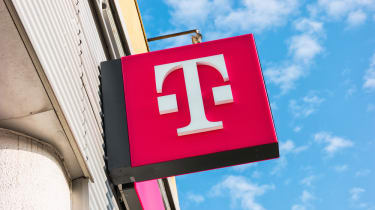 A pink T-Mobile logo on a storefront in Aachen, Germany