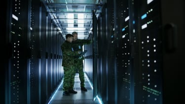 Military personnel examine a server
