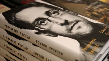 Edward Snowden&#039;s face on a pile of books