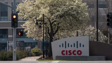 A Cisco sign on a street corner next to a red traffic light