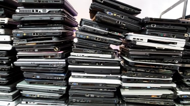 Piles of broken laptops stacked up endlessly