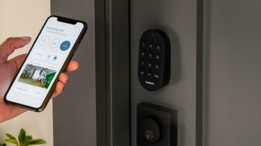 a person using the SimpliSafe app on a smartphone to unlock a smart lock